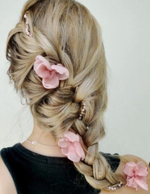 Пышная коса с нежными розовыми цветами отлично подойдет для торжества - ты будешь выглядеть празднично и в то же время неагрессивно, легко и естественно.